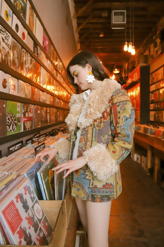 "Nice girl but she is abusing the records..ouch"

Flipping looking at vinyl record albums in the 1970's