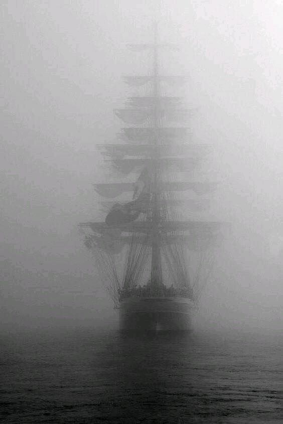 Tall Ship sailing in dense fog , wind and rain and sleet