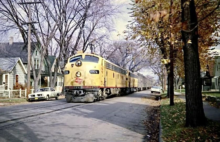 Train Moves slowly down suburban street
