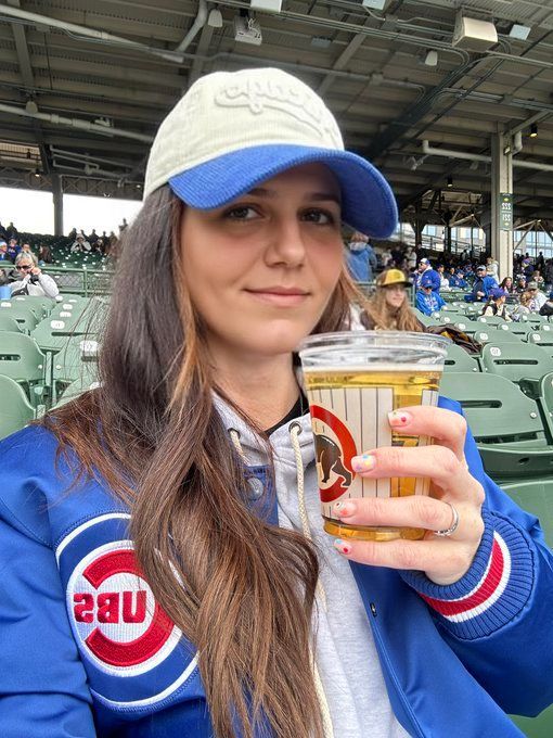 She Takes a sip of beer almost gags and laughs with a gleam in her eyes and fun and happiness on her facre