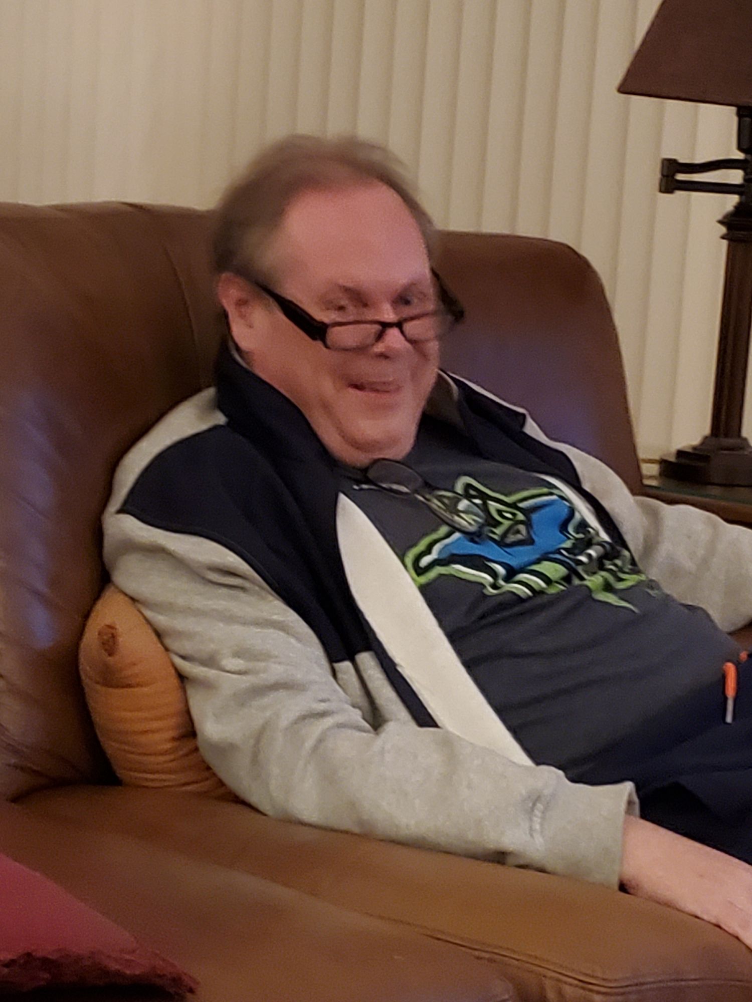 "Self Portrait ?" 

Fatherly Looking Man sitting slightly slouched reading looking over at you with his glasses slid down his nose blue eyes 

split-complementa...