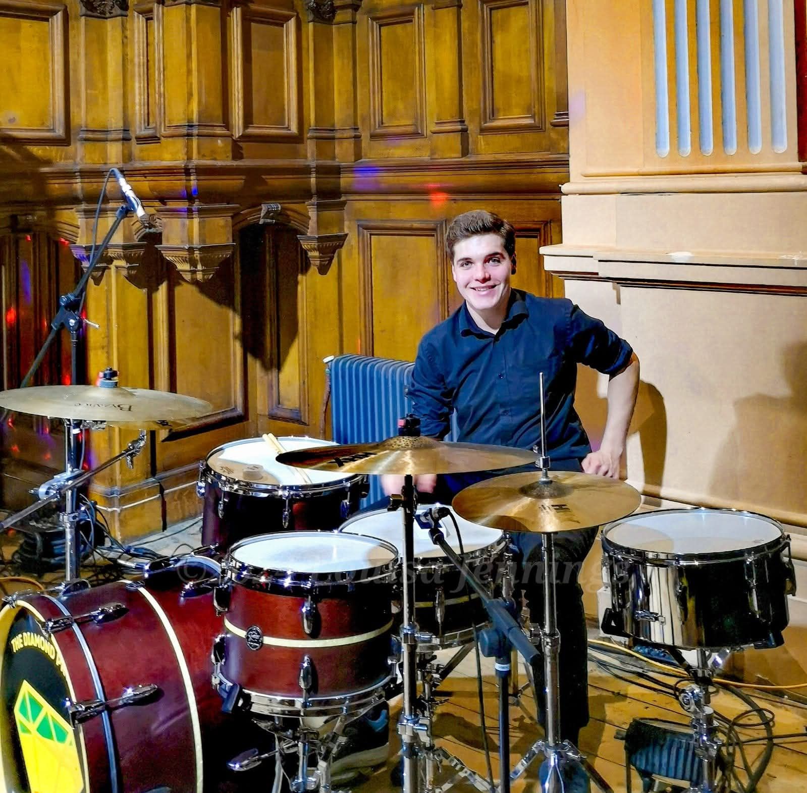 <lora:flux-artsy:1.0> "Vibrant impressionist painting of a drummer performing passionately, rain falling in diagonal streaks, bold brushstro...