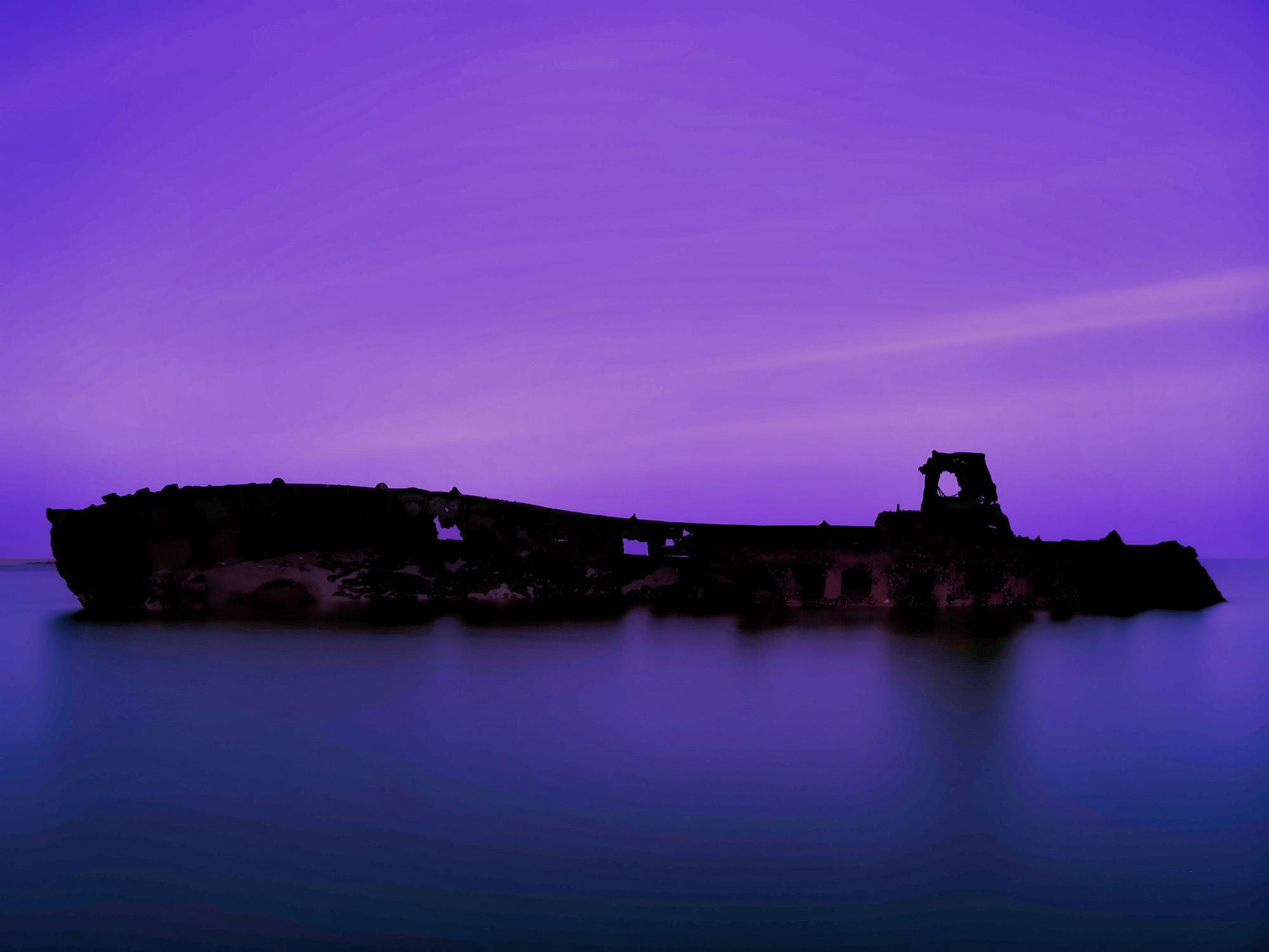 “Use the reference image of the Bromhill Sands shipwreck. Keep the shipwreck’s exact shape and perspective intact, but transform the scene i...