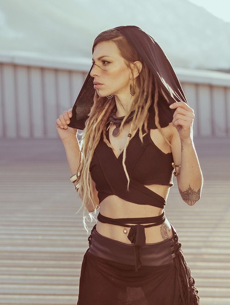 A stunning photography of an Indian fit warrior woman, blending elements of a Thug and a Ninja. She confidently holds a dagger in one hand a...