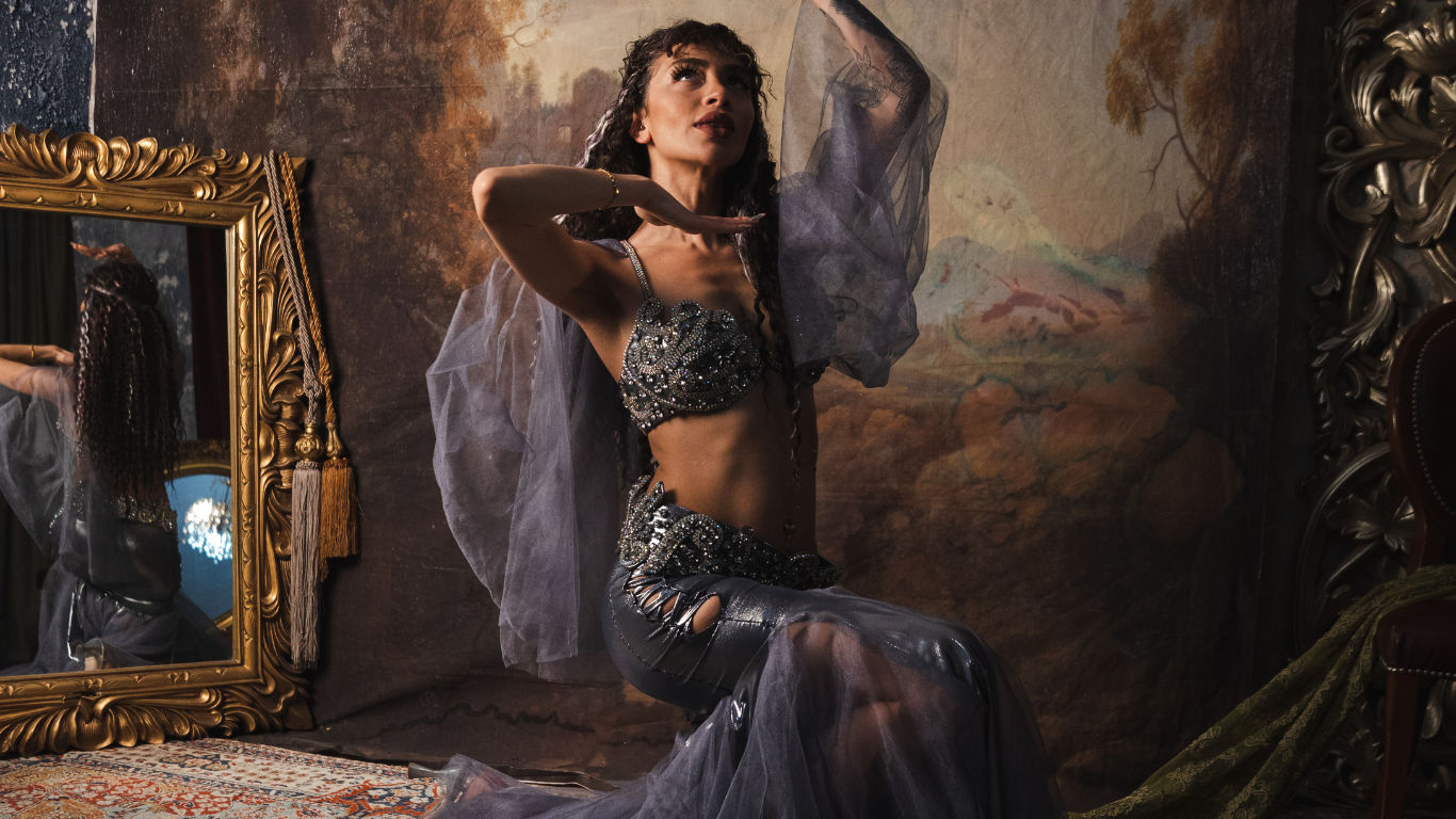 the iconic picture of a gorgeous  faerie woman with a red and black dress with laces and intricate patterns, long needles  in the hairs, des...