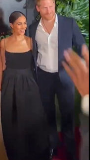 Megan markle  black skin, hair bun, red, green , yellow hat and prince harry reggae yellow and red hat jamaica