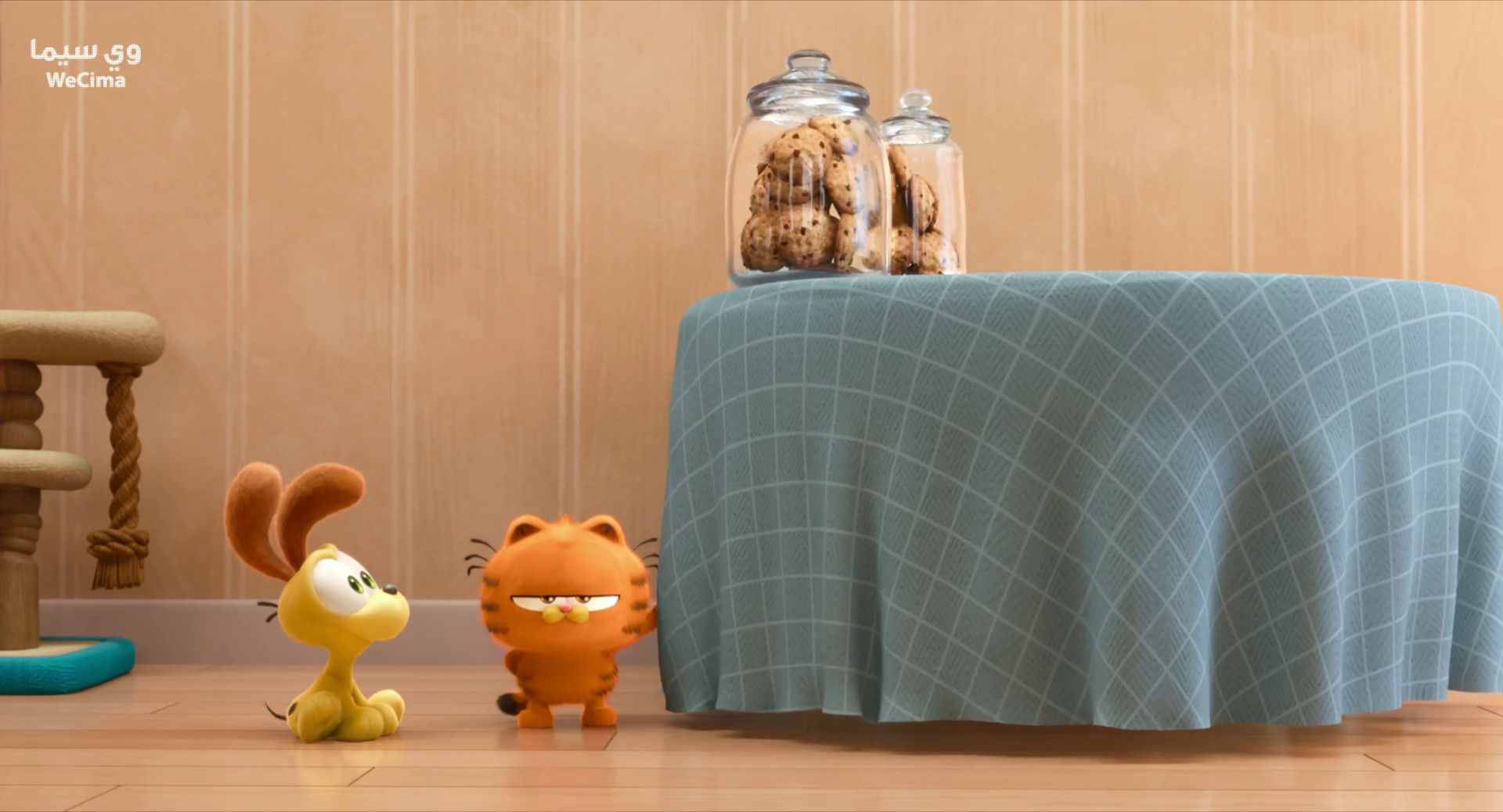 The image shows a small yellow dog with large floppy ears and a small orange cat with black stripes. The two characters look at a table cove...