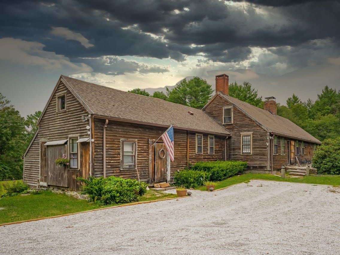 Super scary, evil, decrepit conjuring house painted black with deep purple and red skies