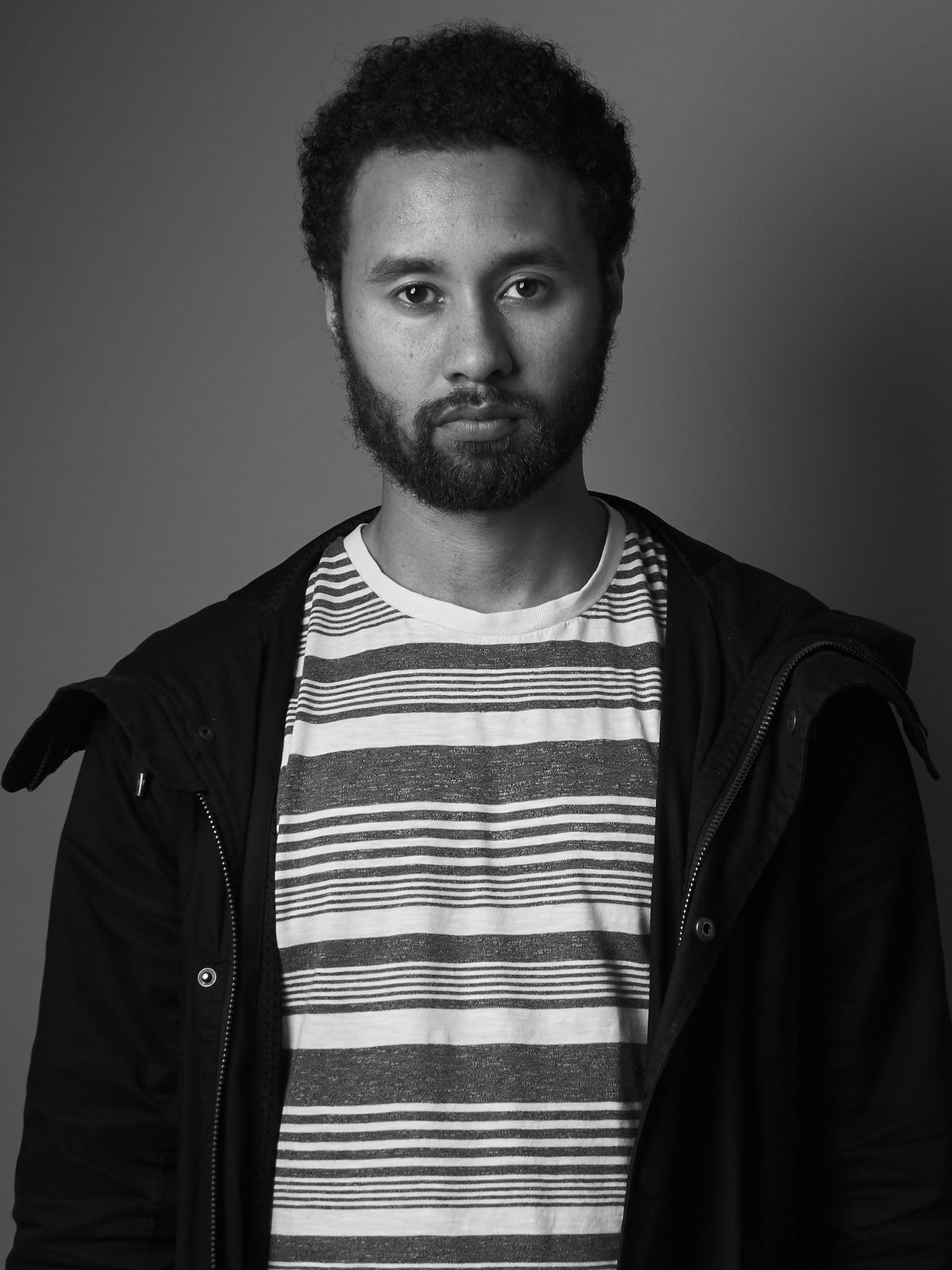 A smiling portrait of my dad in a casual outdoor setting with a warm sun