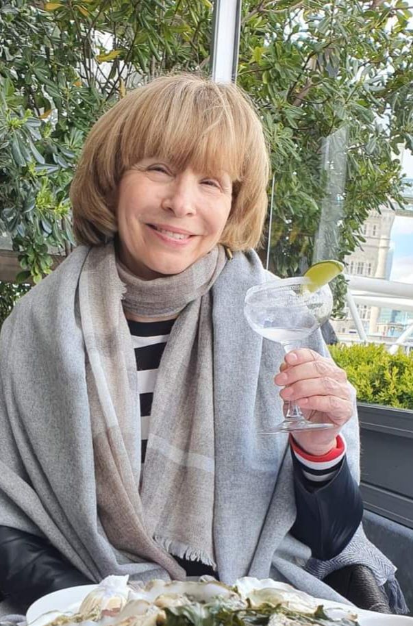 A 35 year old lady with a round face, in beautiful formal attire, sitting in her modern style living room, relaxing Mark Brooks and Dan Mumf...