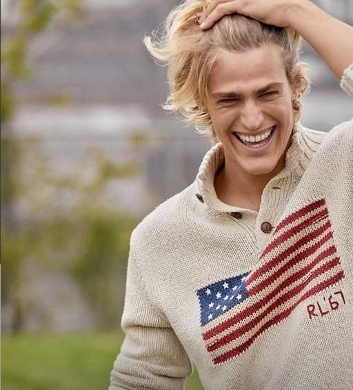 Hyper-realistic casual photo of an extraordinarily handsome blond man,21, sweeping his shoulder-length hair from his forehead to the top of ...