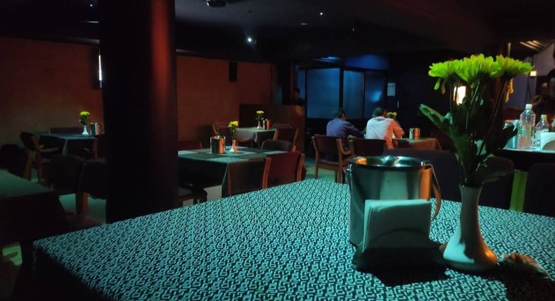 Ambience: Warm lighting, flickering neon signs, glowing bar counters.
Name board: Prashant Bar
Movement: People chatting, bartenders mixing...