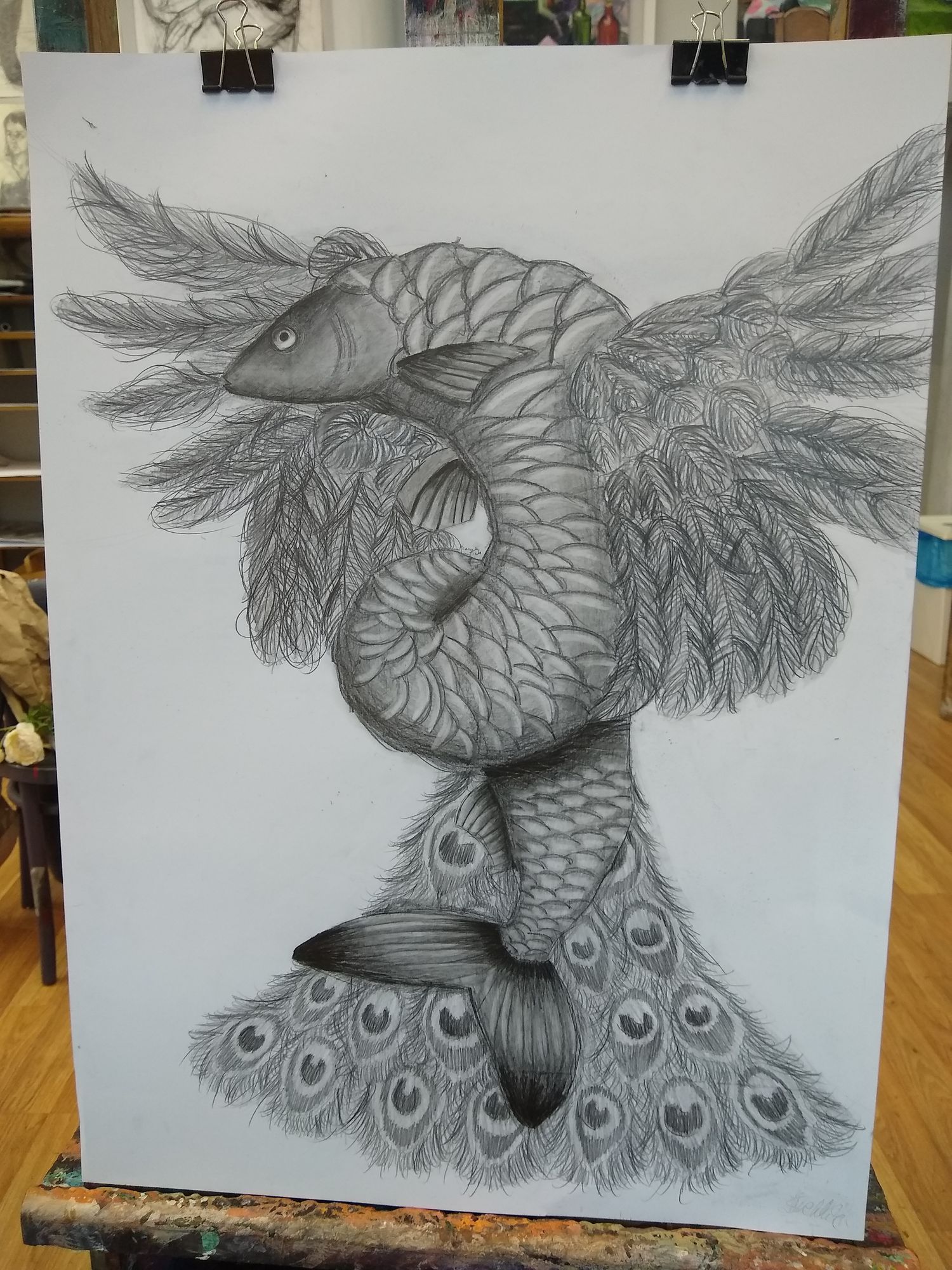 A fish with peacock tail and peacock wings