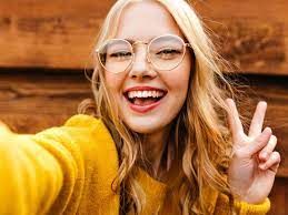 A WOMAN WITH YELLOW DRESS IN GARDEN AND HORSES