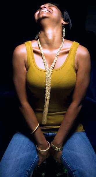 The edited image maintains the same composition and style as the original, featuring a woman seated against a dark background, her body fram...