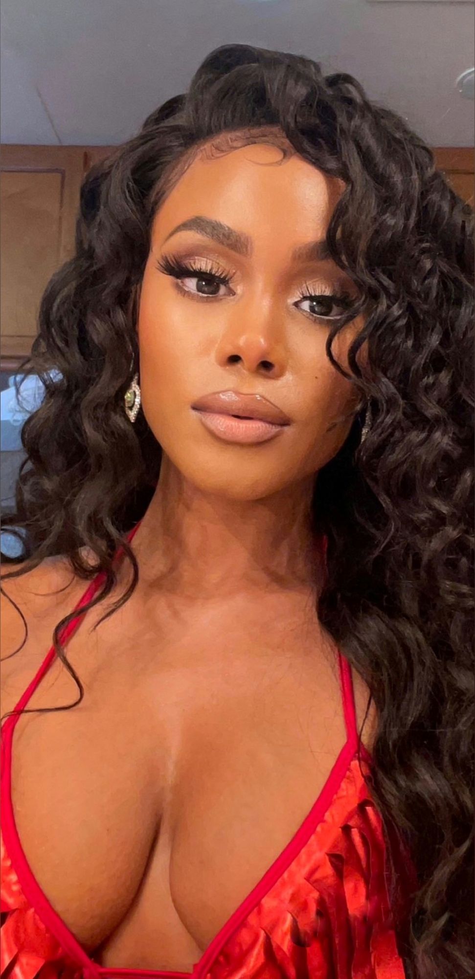 create an image of an African American woman with long, dark, wavy hair cascading over her shoulders. She has a warm skin tone, full lips wi...