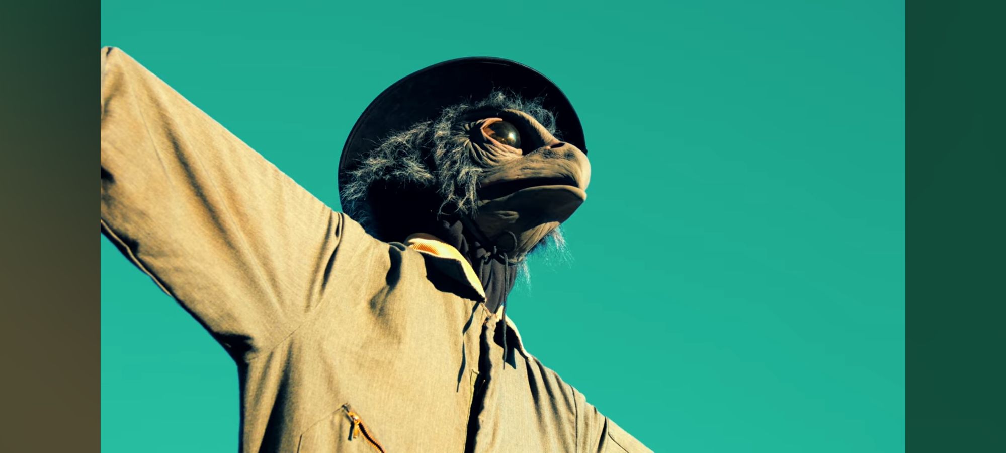 A creepy 80s horror movie poster featuring a scarecrow in a cornfield with a bird mask and an axe. Use airbrush look with associated horror ...