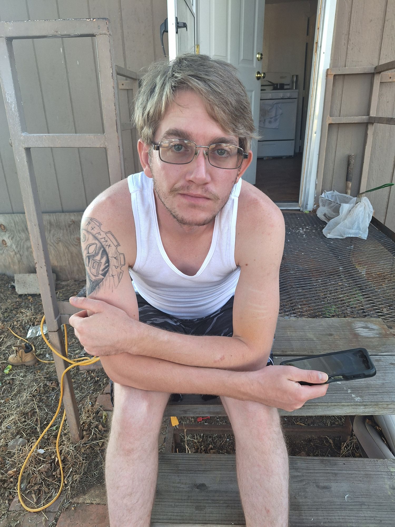 Handsome man sitting in forest