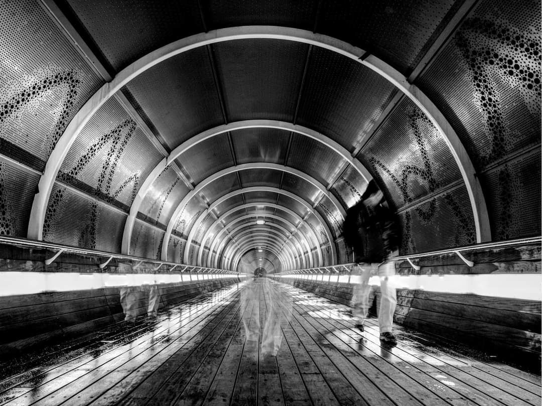 Close up of white woman, aged 35, short cut swedish blond hair, green eyes, blue leather low cut dress, not to skinny. A bit dirt over her b...