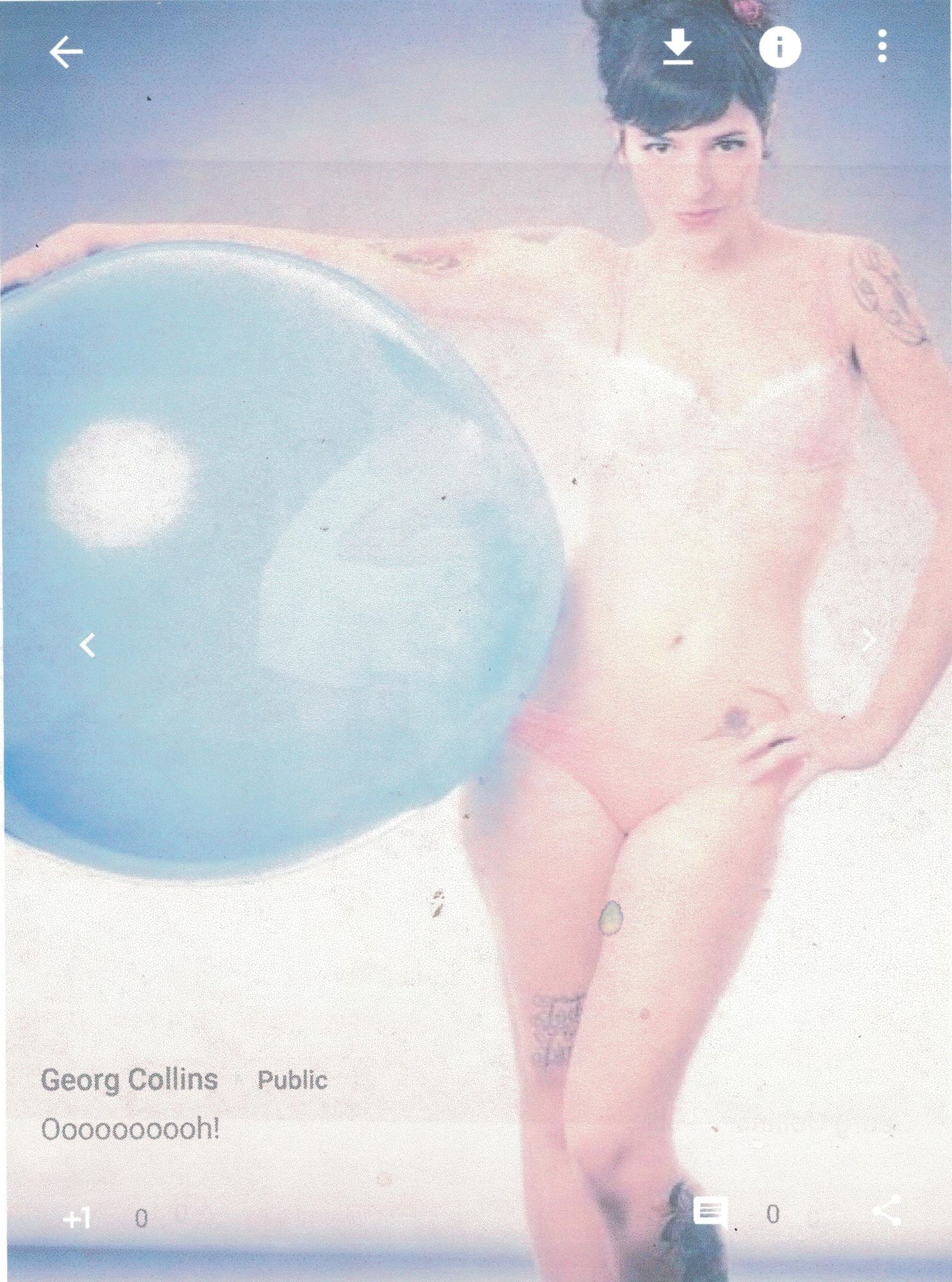 A beautiful British woman holding a big balloon tucked under her arm.  