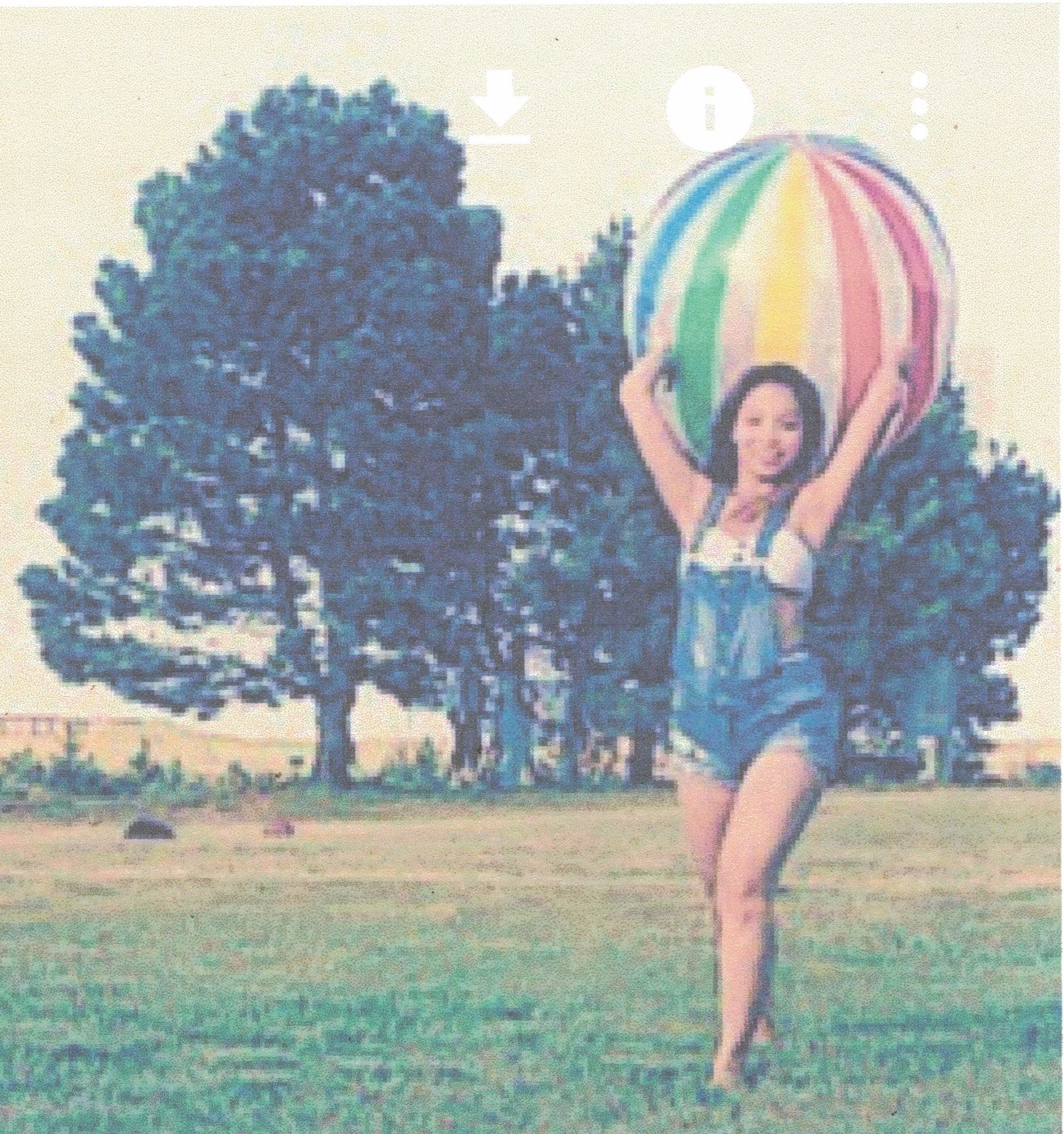 beautiful cowgirl holding a beach ball