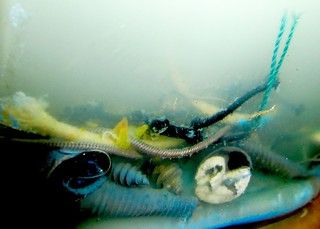 A collection of reflective metallic metal orbs in the reflection you can see the artist or some random Monster in the style of illusionist a...