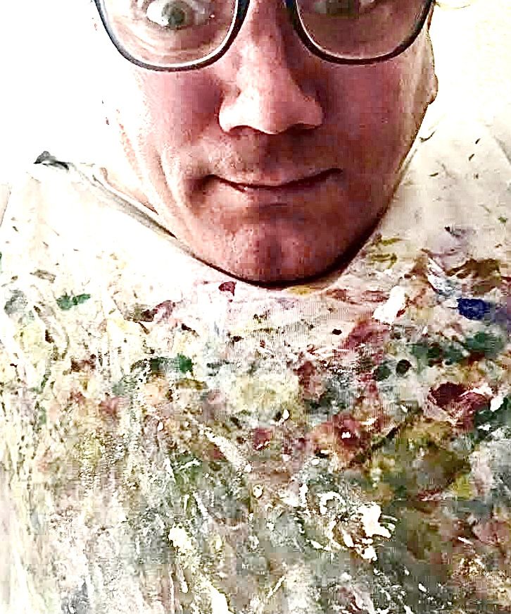 A goofy-looking artist accidentally snapped a selfie of himself wearing a work attire featuring one of his own abstract artworks