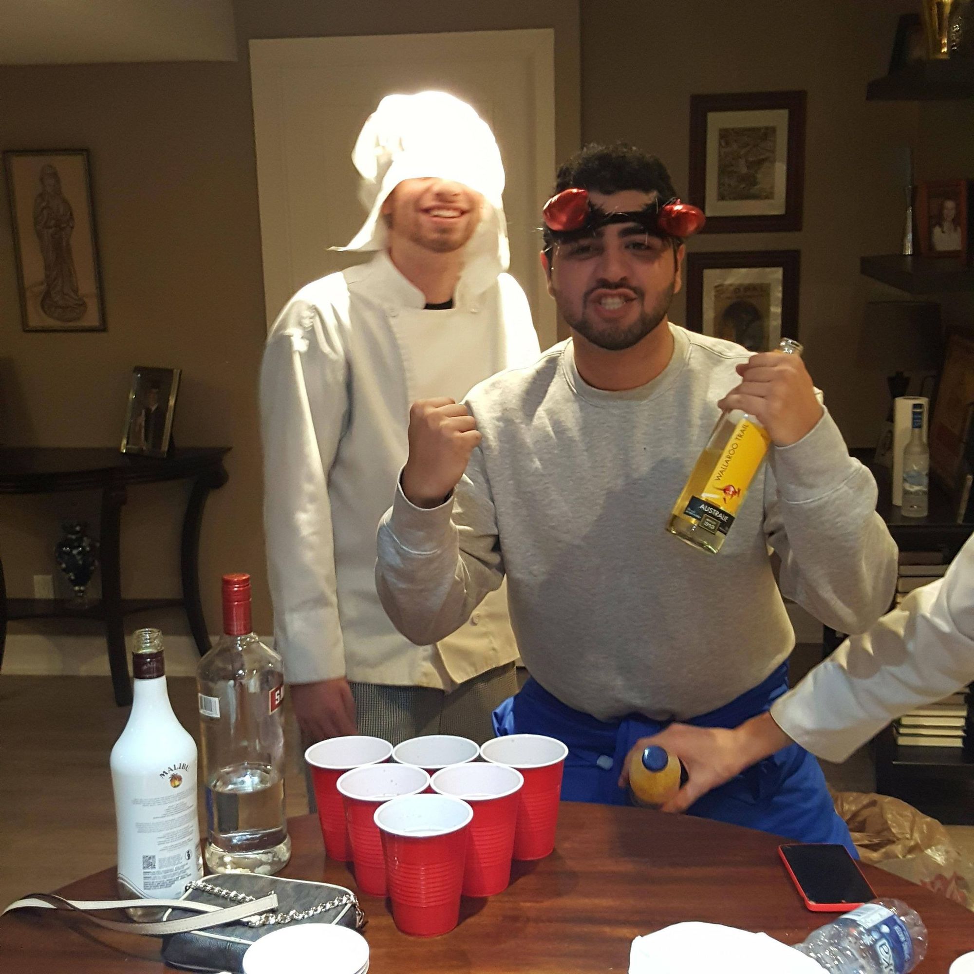 Goofy chef and friend win the pong game