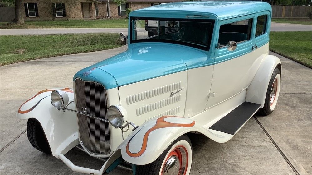 Stretched white Kia Soul Hot Rod, with flared fenders. Chrome Rims. Slightly bigger tires in the back. Smaller tires in the front! 
Hot Rod...