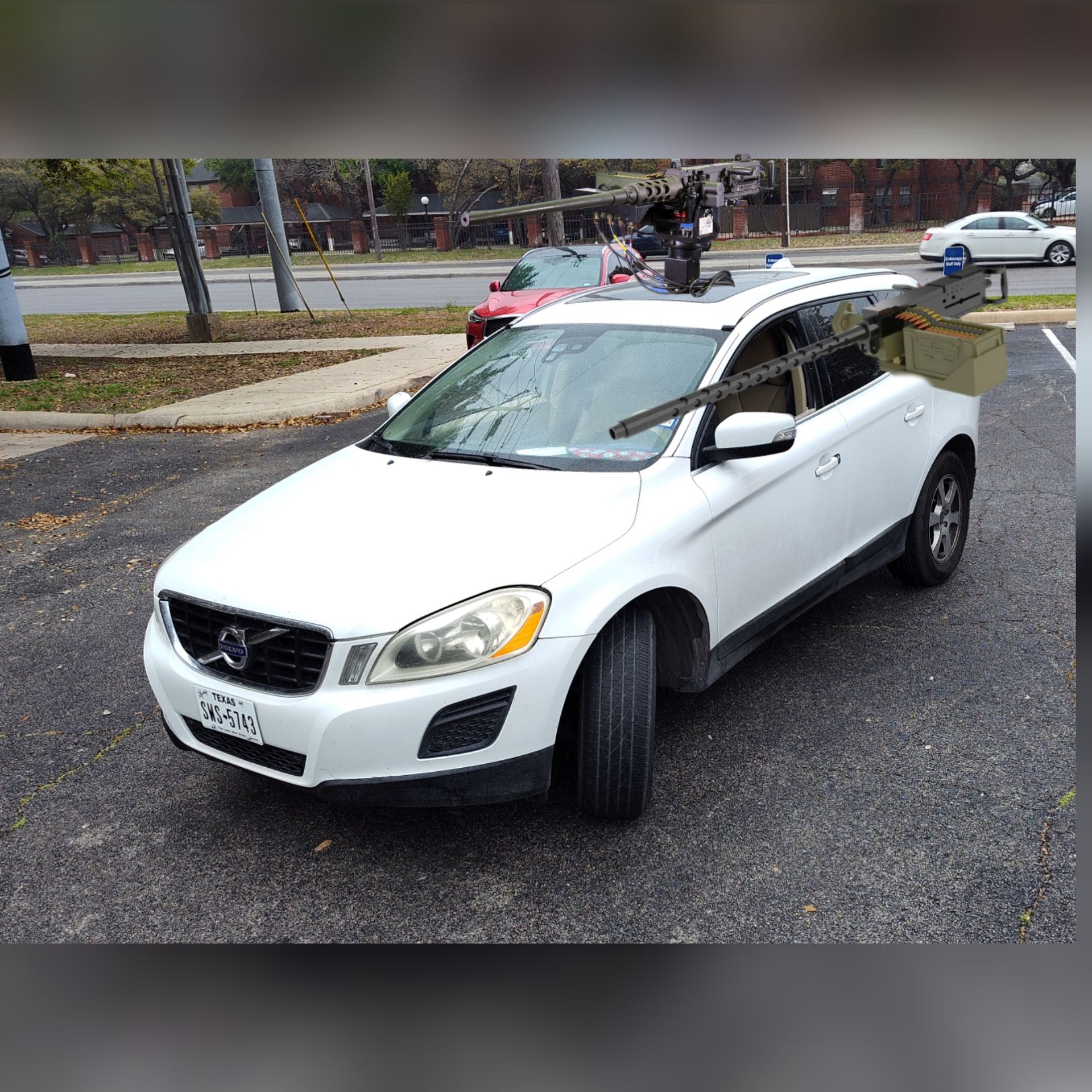 2011 Volvo XC60 armored vehicle outfitted with 50 caliber machine guns, tank tracks 