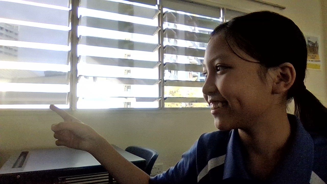 A young girl gesturing the way to a small coffee shop 