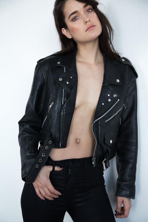 Noemie Merlant ultrarealistic face, super detailed ultrarealistic, Dark hair, ultrarealistic superdetailled white shirt and black leather bi...