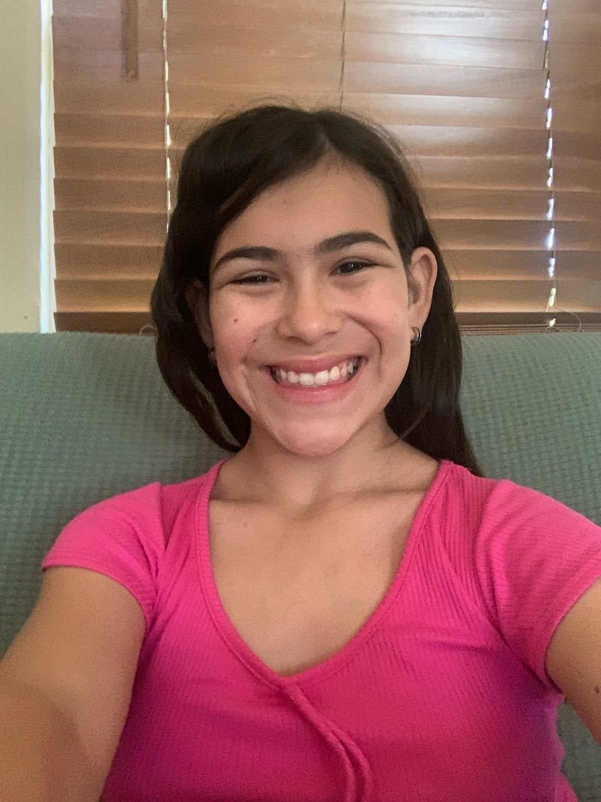 A girl wearing a puffer jacket with the hood over her head