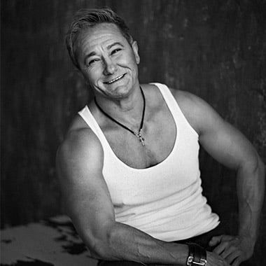 
Make copi of this photo  a person with a muscular body like a man; he wearing short denim shorts with a torn effect and a white tank top. P... - Start Image 1