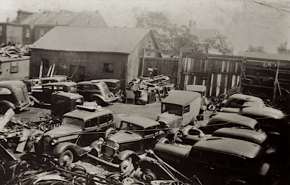 NYC 1935; Inner city auto wrecking yard, bleak, slum, rundown, many wrecked 1920's and 30's cars, circa 1935, more industrial slums in the b...