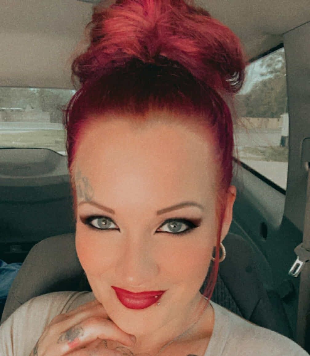 <lora:PinupFlux:1.0> <lora:Darkly Magical:1.0> <lora:Wild Serenity:1.0> Vintage woman large green eyes with burgundy eyeliner red ruby lips ...