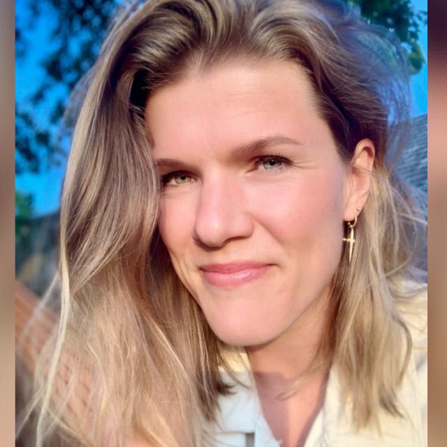 A sportive woman working in a dreamy vegetable garden with butterflies and al lot of colours.everywhere