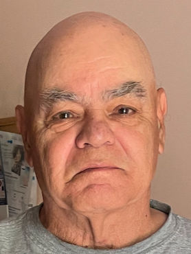 close-up of <lora:dad:1.0> sci-fi protagonist, Futuristic minimalist curved scandi spaceship interior, dim lighting, colorful warm glowing l...