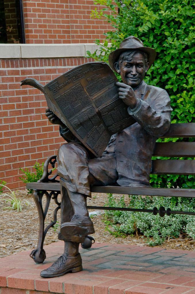 Man reading late 1950s reading newspaper at the tain station 