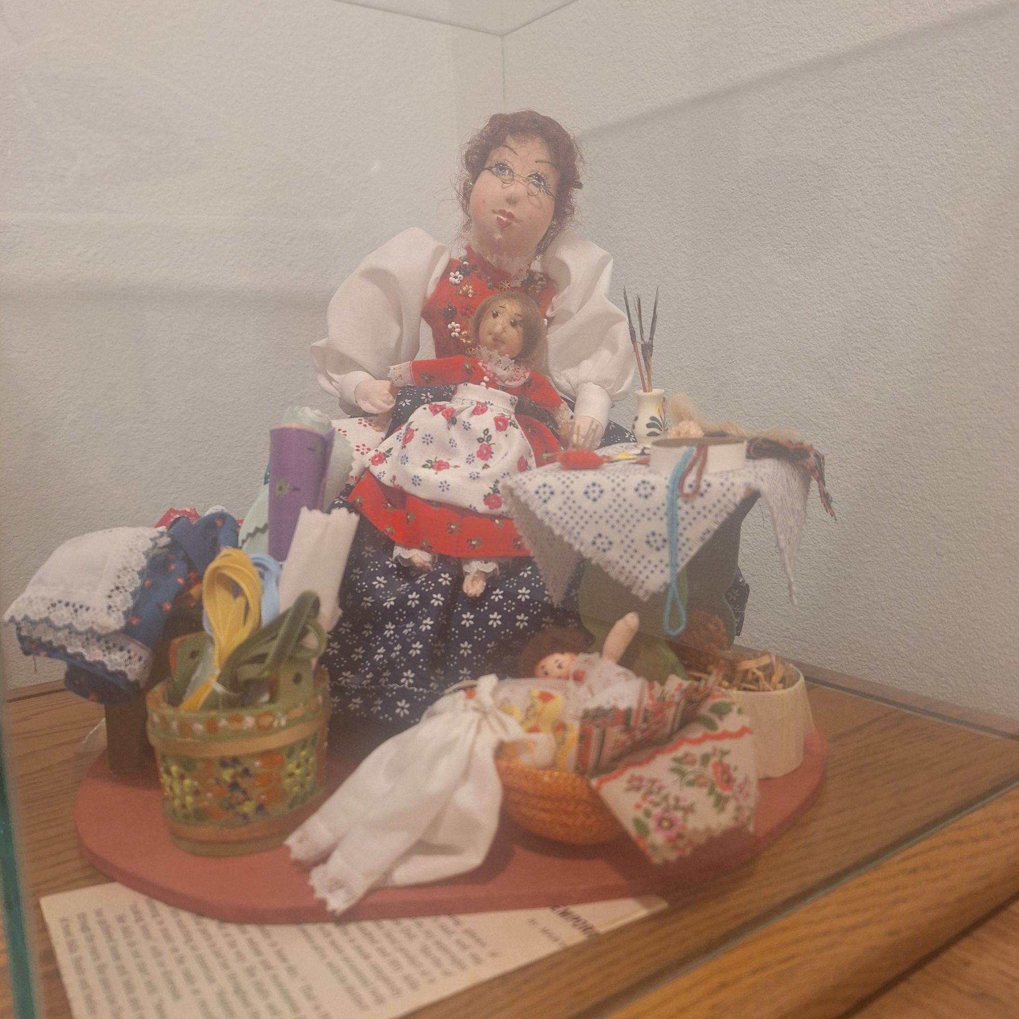 A doll maker working.  In the late night.  Fire flickering.  Fine details. Watercolor 