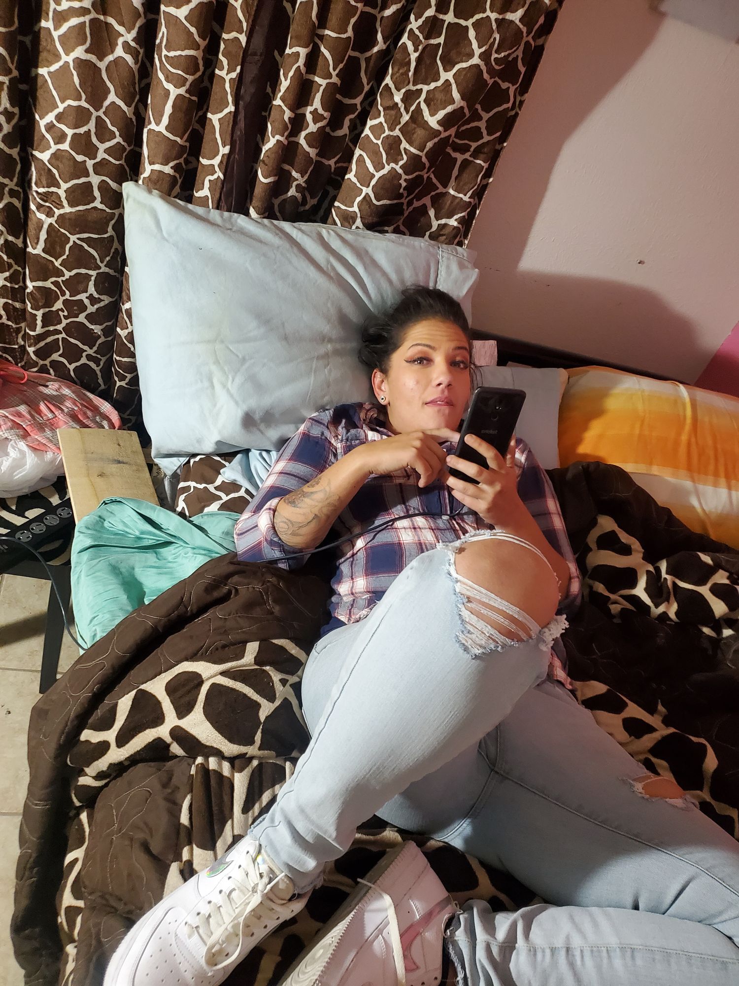 Rockabilly style woman, sitting on the hood of an upgraded hot rod car. her clothes are red and black . intricately detailed man sittin in t...