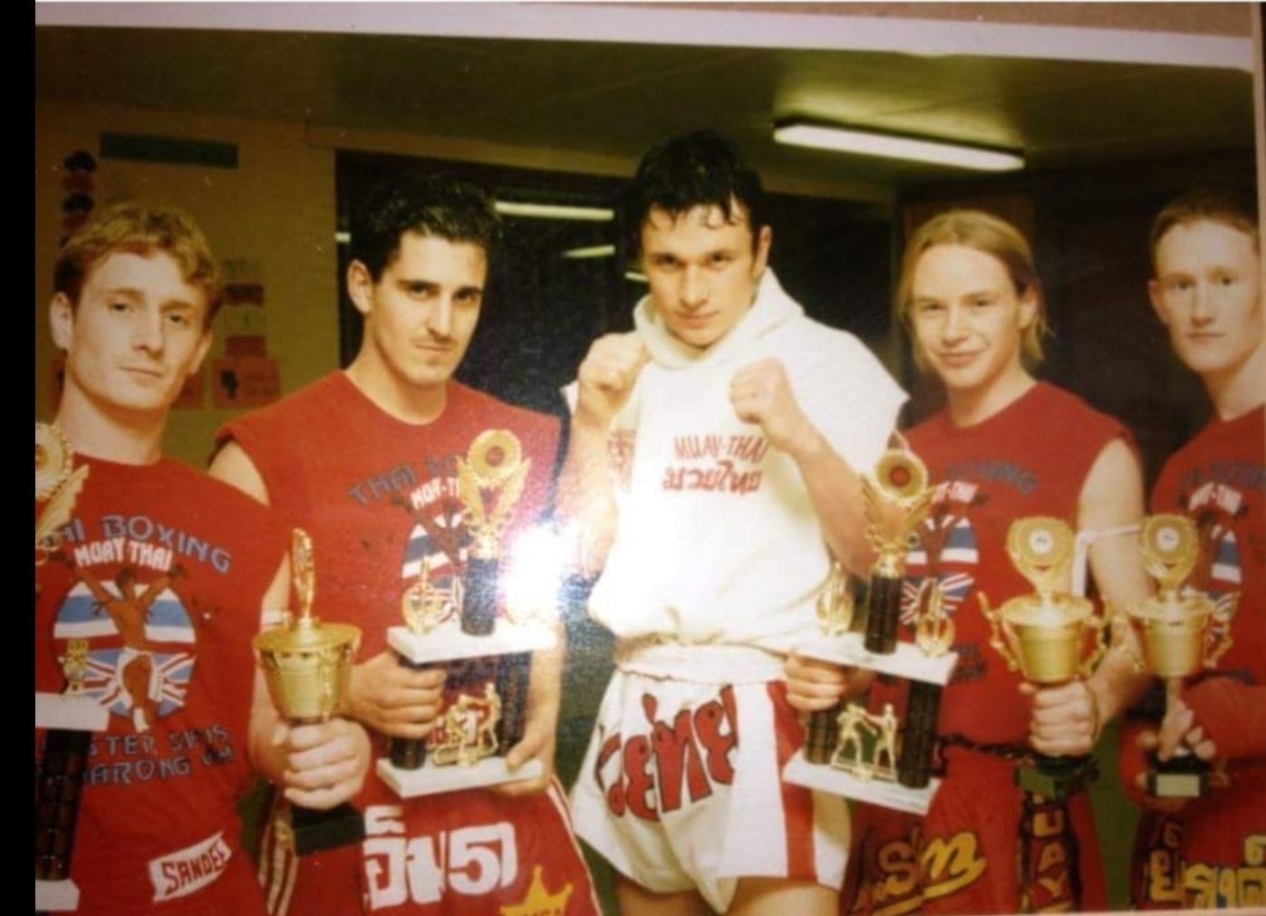 Muscly Thai boxers laughing