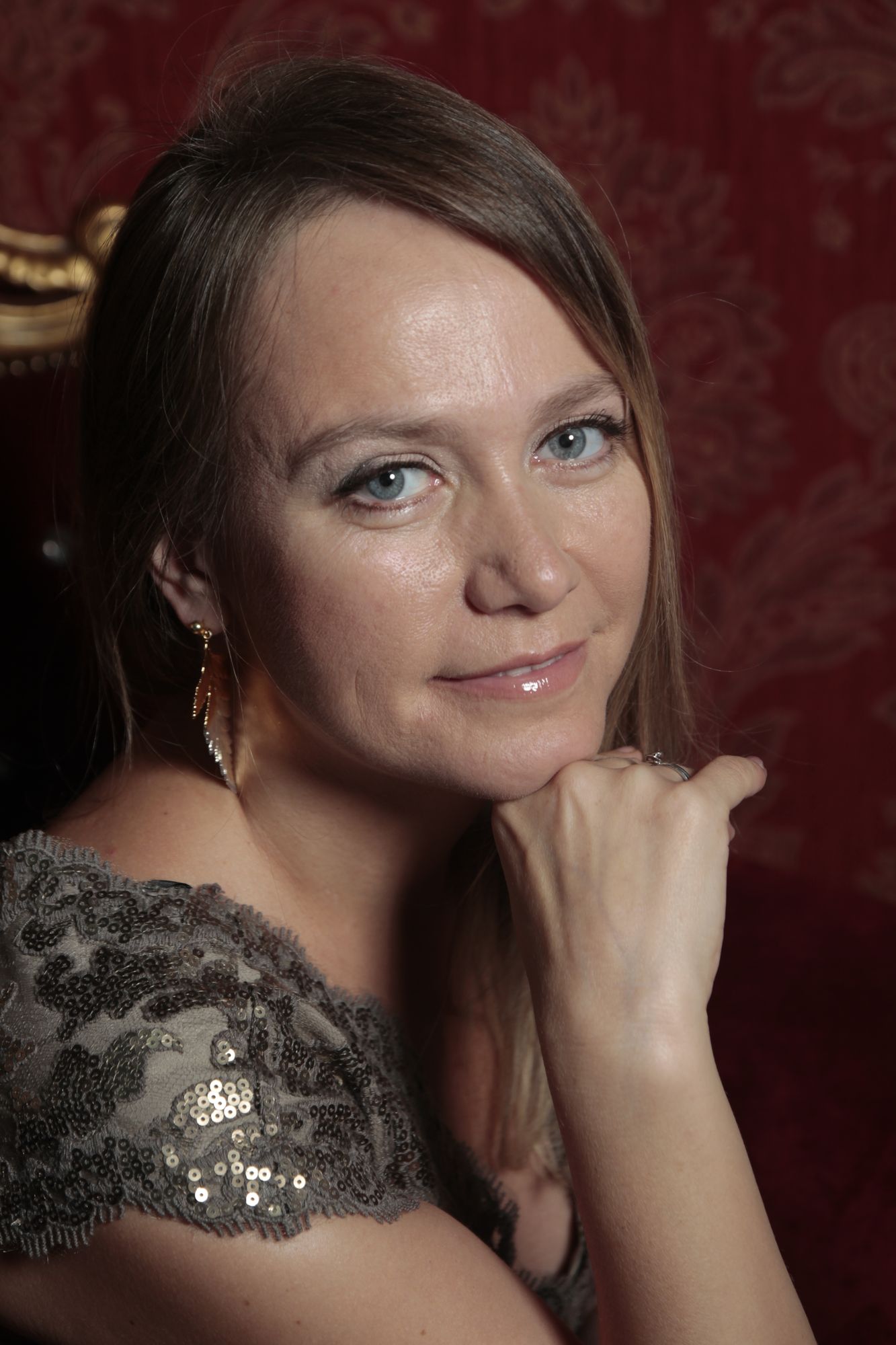 A lone astronaut standing on a crimson desert planet, gazing at a colossal, ringed gas giant dominating the alien sky. Crystalline rock form...