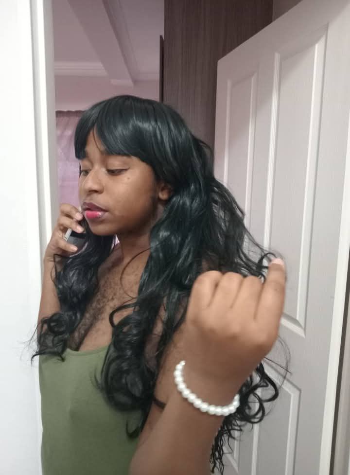 Woman in a gorgeous diamanté wedding gown with spritzing perfume on herself