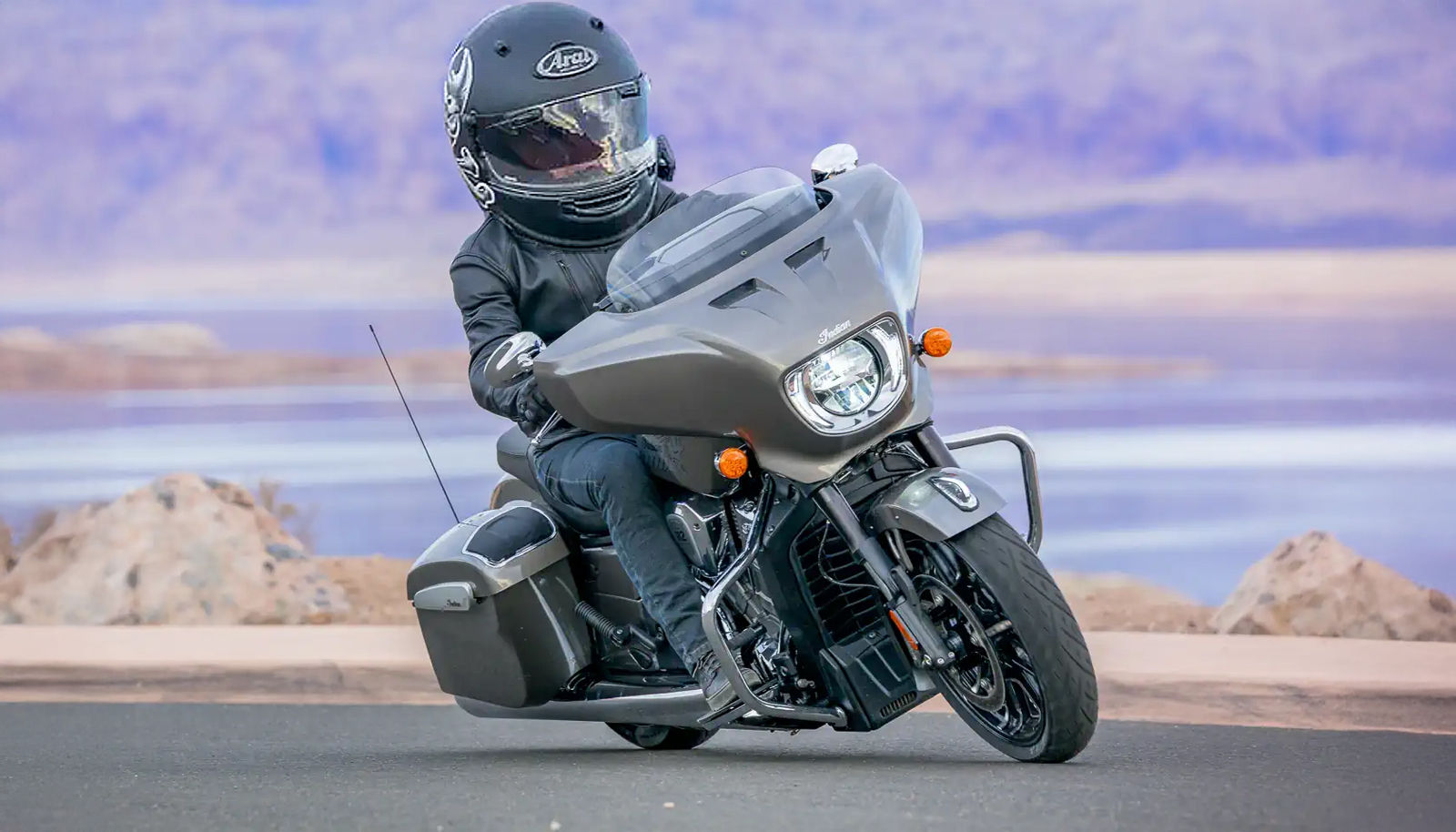 A miniature biker riding a toy Indian Motorcycle in a toy model scale highway.