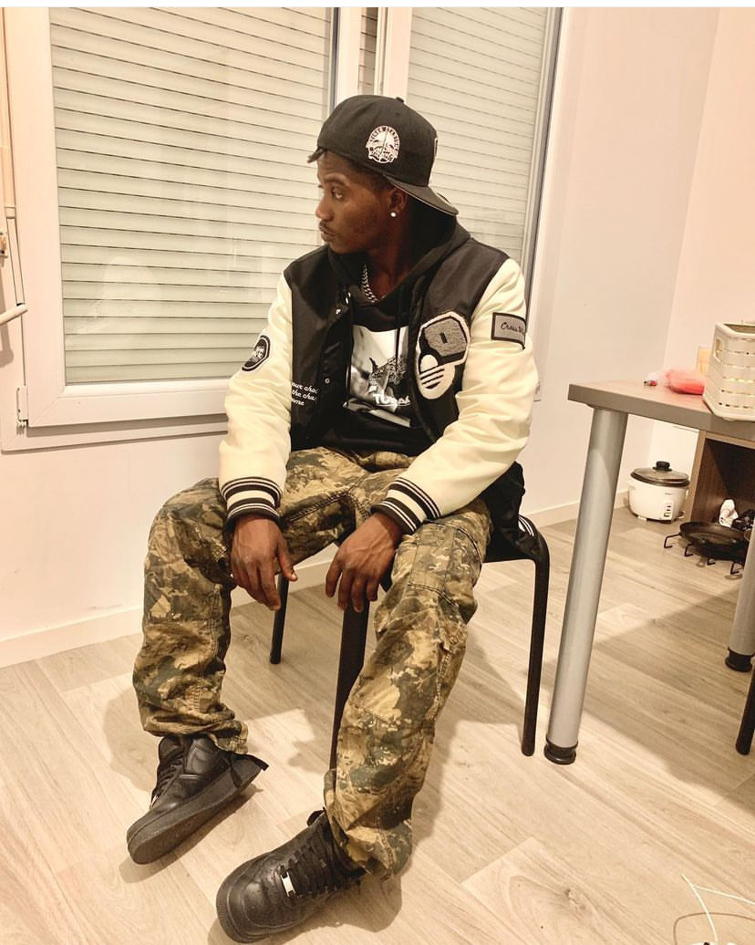 A massive, ethereal ghost ship sailing through a glowing, misty ocean under a star-filled night sky. The ship has tall masts with tattered s...