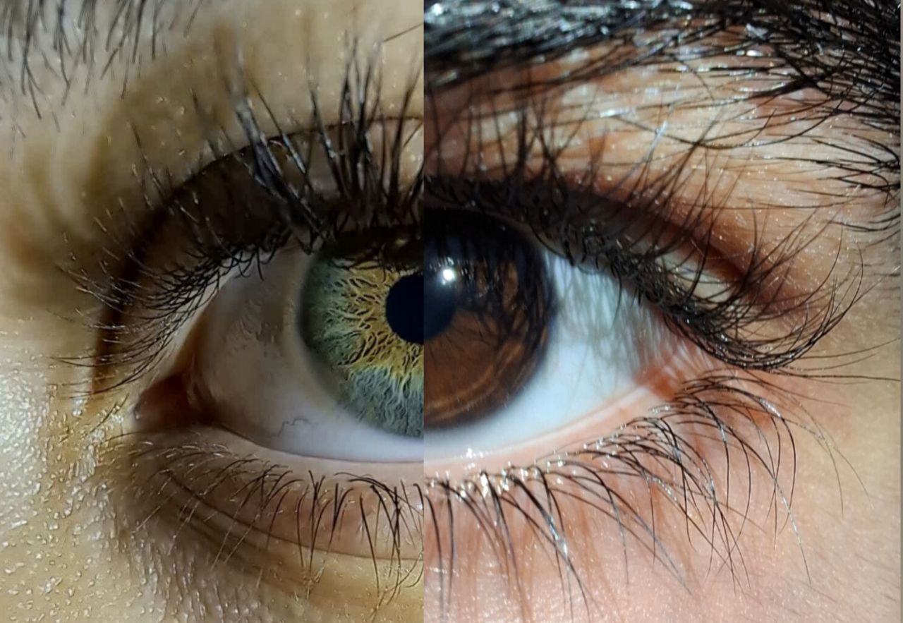 Two glowing irises floating in the center of a pure black cosmic background, one iris on the left and one on the right. 
Between them, a rad...