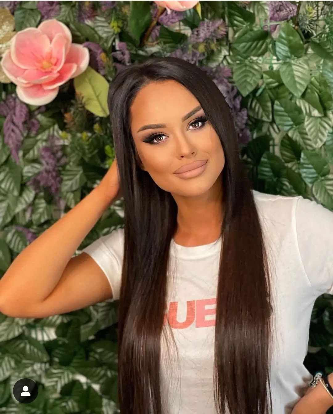 beautiful tattooed girl with a cup of tea in her hand, looks sick, but at the same time smiling and beautiful, flowers 