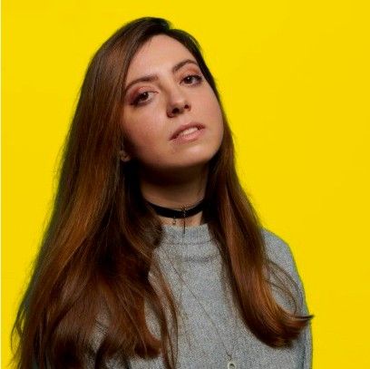 A Renaissance portrait of a noble, richly dressed and poised, with a distant yet intense gaze. Brown round eyes.