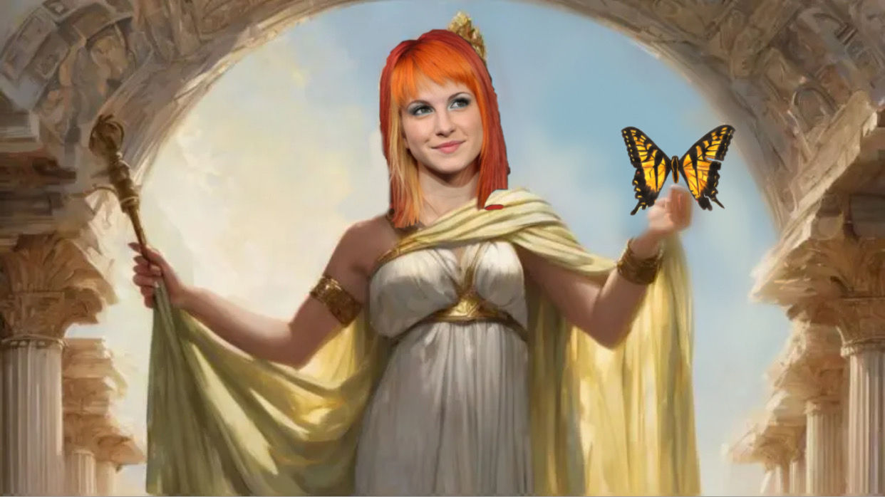 Hayley Williams as a Greek goddess with flaming orange hair holding a butterfly